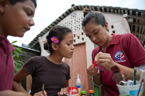 A PeaceCorps member conducts arts project with Guatemalan children