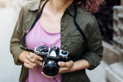 A woman holds a camera