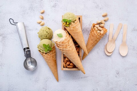 ice cream scoop, cones and spoons on white background