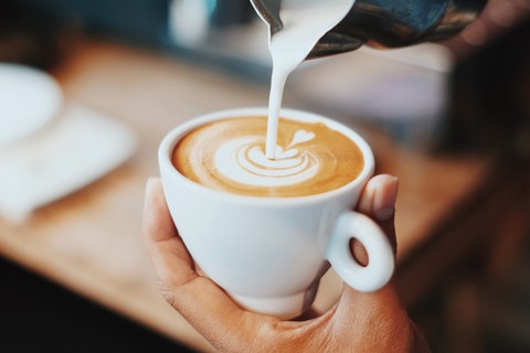 Milk pouring into latte design
