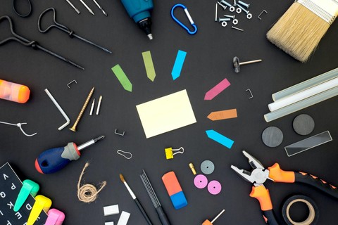 Various office supplies and working tools scattered on a desk