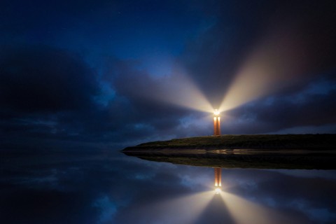 Lighthouse shining in the dark