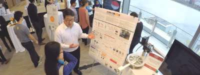Person presenting to student from poster board