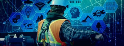 Construction worker standing in front of a field of digital icons