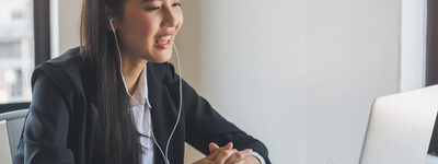 A person taking a meeting on their laptop.