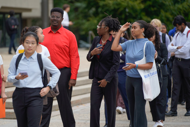Students standing outside in line waiting to enter the fall career fair-fcf