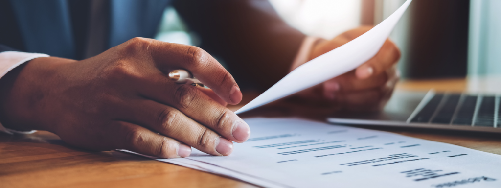 A person looks closely at a resume.