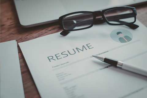 resume, pen and glasses