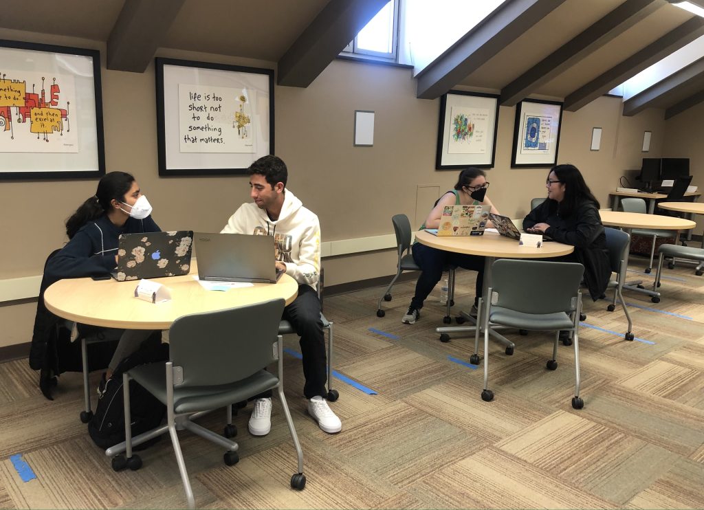 Four students sitting around a table