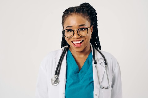 Black woman in scrubs.