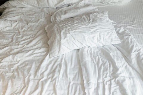 Wrinkled pillows and sheets.