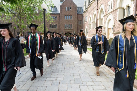 Graduates walking in cap and gown