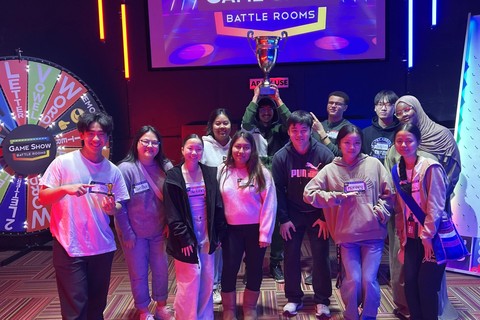 group of students with one holding a trophy