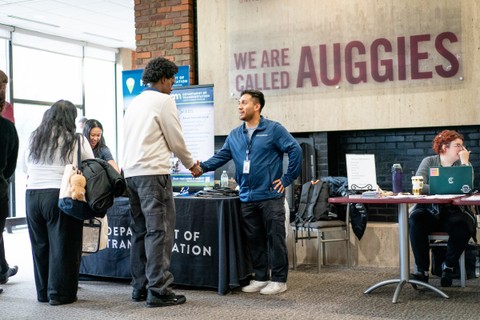 student shaking hands with recruiter