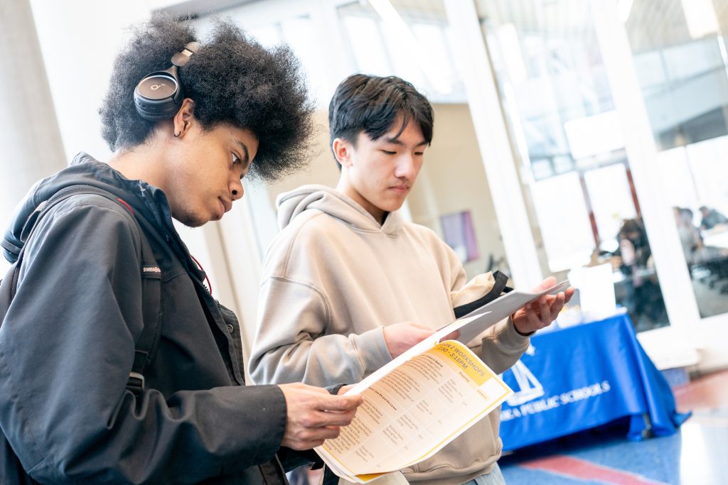 A student is looking through a paper packet.