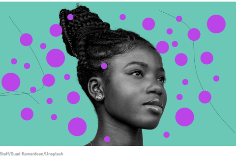 Image of a back woman with braids up in a bun.