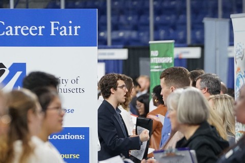 People standing and talking at a career fair