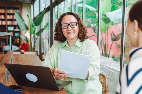 A professional reviewing and providing feedback on a resume for a young professional.