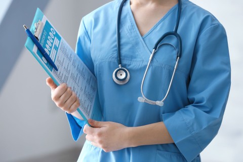 student nurse holding a clipboard