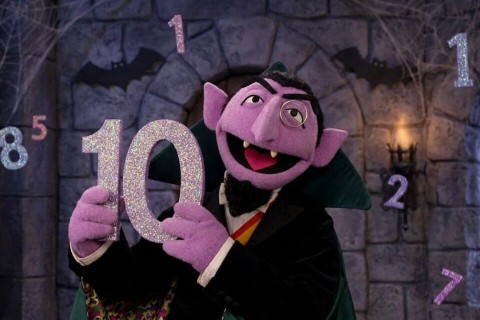 The Count from Sesame Street holding the number 10.