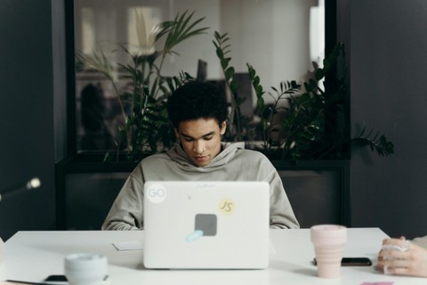 man sitting in front of a laptop