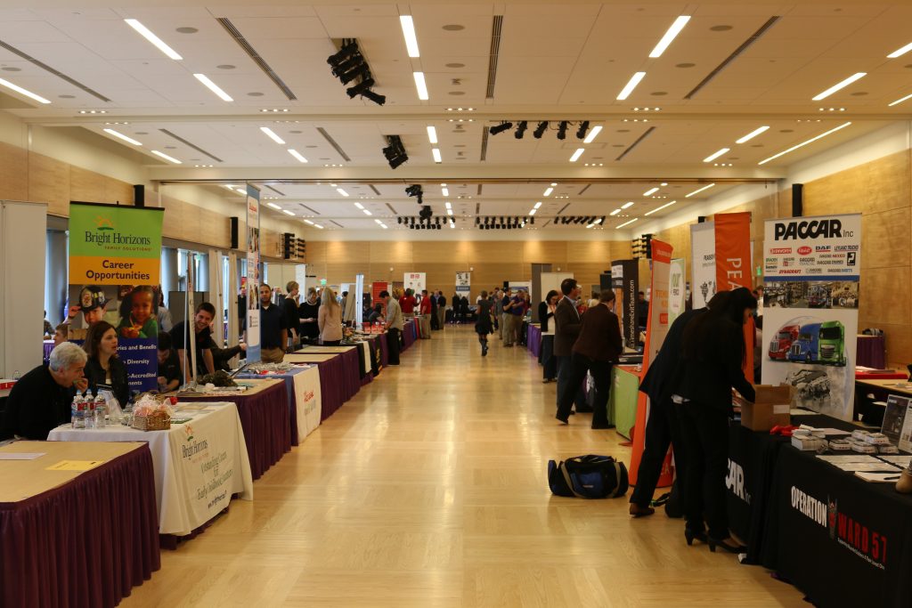 Employers have set up their booths with their signage and decor, and a few students are beginning to walk through the walkways.