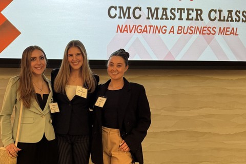 Three students standing in front of a sign for the CMC Master Class event.