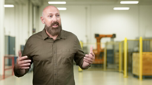 Professional Man in a manufacturing facility presenting important information. 