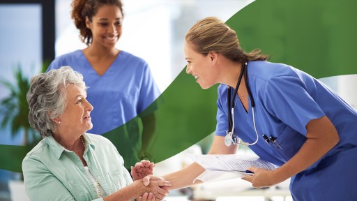 Two healthcare professional assisting a patient