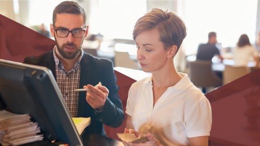 Two co-workers meeting to discuss information