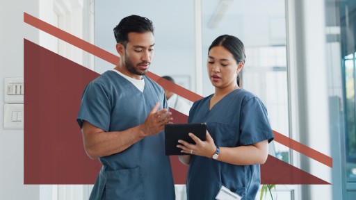 Two healthcare professionals talking about data on an ipad