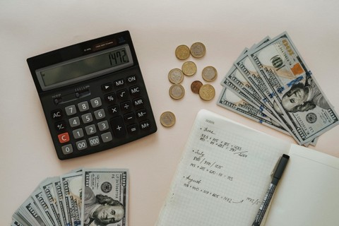 Image of calculator, money and notes