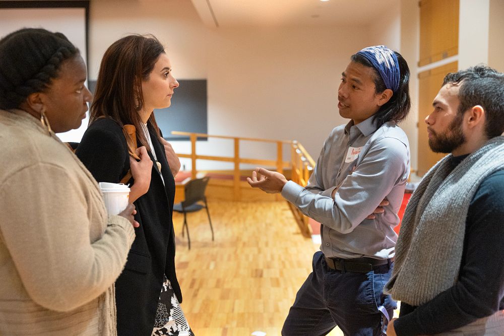 Image of four people talking