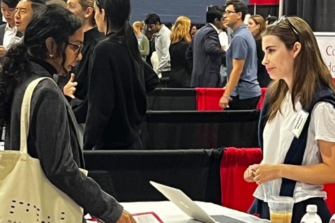 A student speakers with a recruiter at a career fair