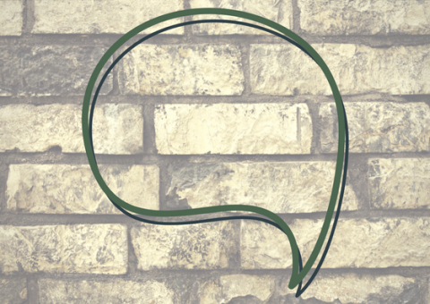 a speech bubble imposed over an image of a brick wall
