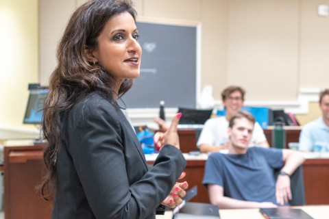 a woman in a suit speaking to a class
