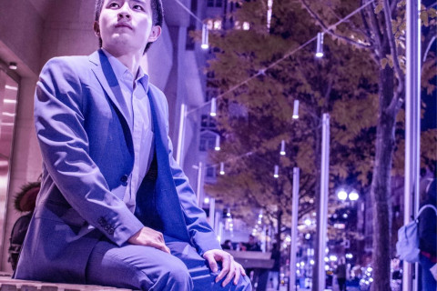 Shawn Shao sitting on bench