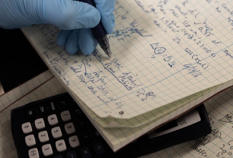 Hand writing lab notes on graph paper