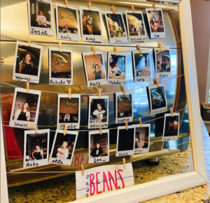 Small photos of Beans Coffee Shop employees strung on twine in a frame