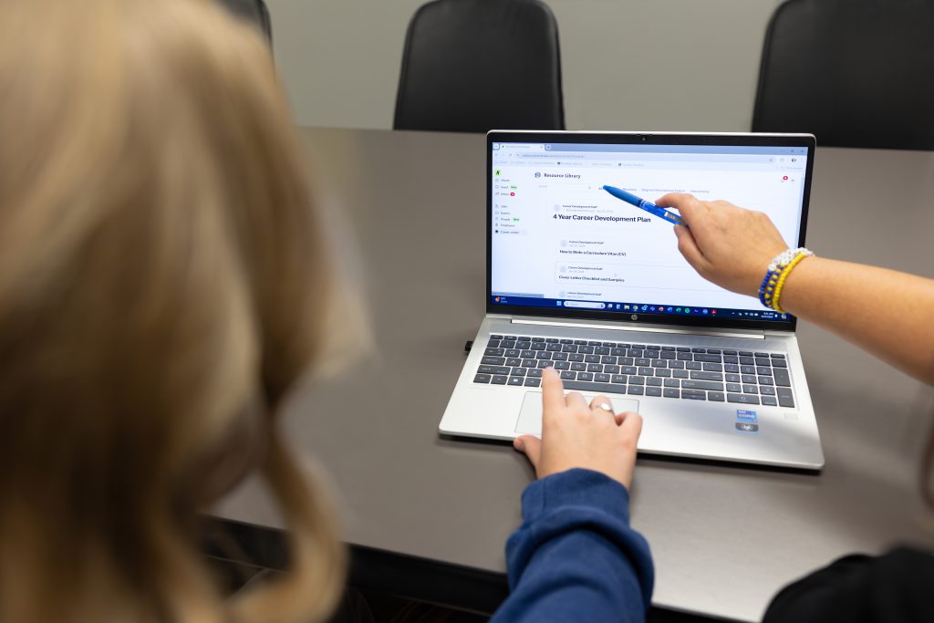 image of a career coach and student looking at an online resource