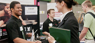 student talking to a recruiter at a career fair