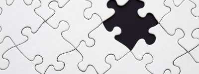 white puzzle pieces connected with one piece missing
