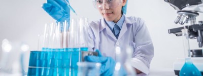 Scientist with glass viles in a research lab