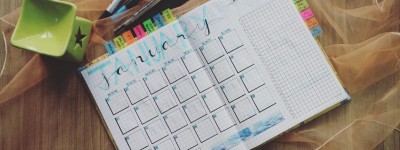 pens and open calendar on a table