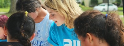 young woman working with children outside