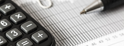 Photo with calculator and balance sheet