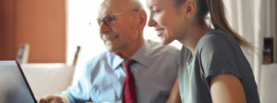 young woman helping man with payment process