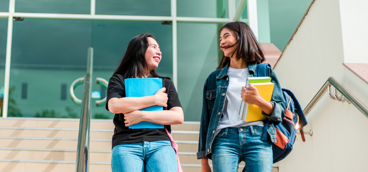 two female students walking down stairway