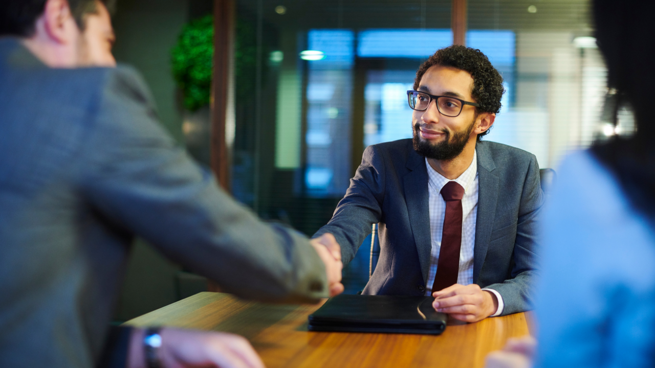 Employer shaking interviewee's hand.