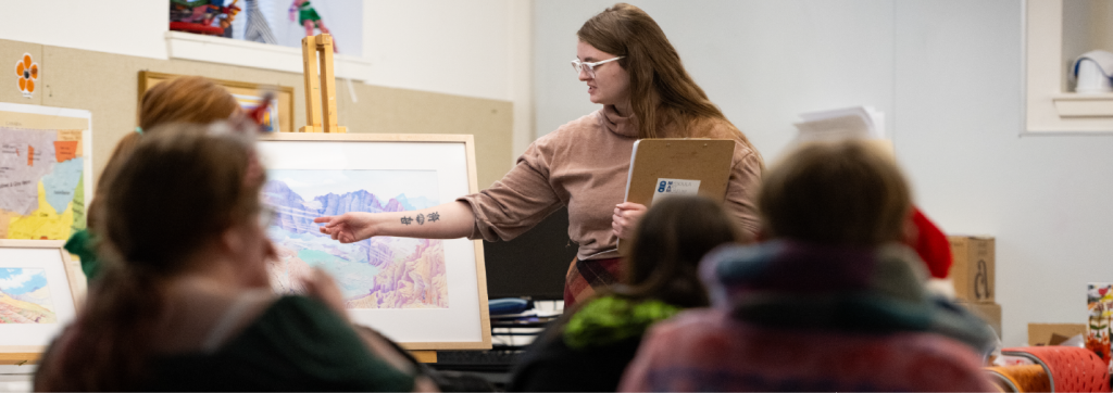 teacher pointing to a landscape drawing